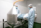 Operators charging powder into the blending hopper