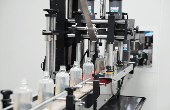 Home care bottles moving through the capping station