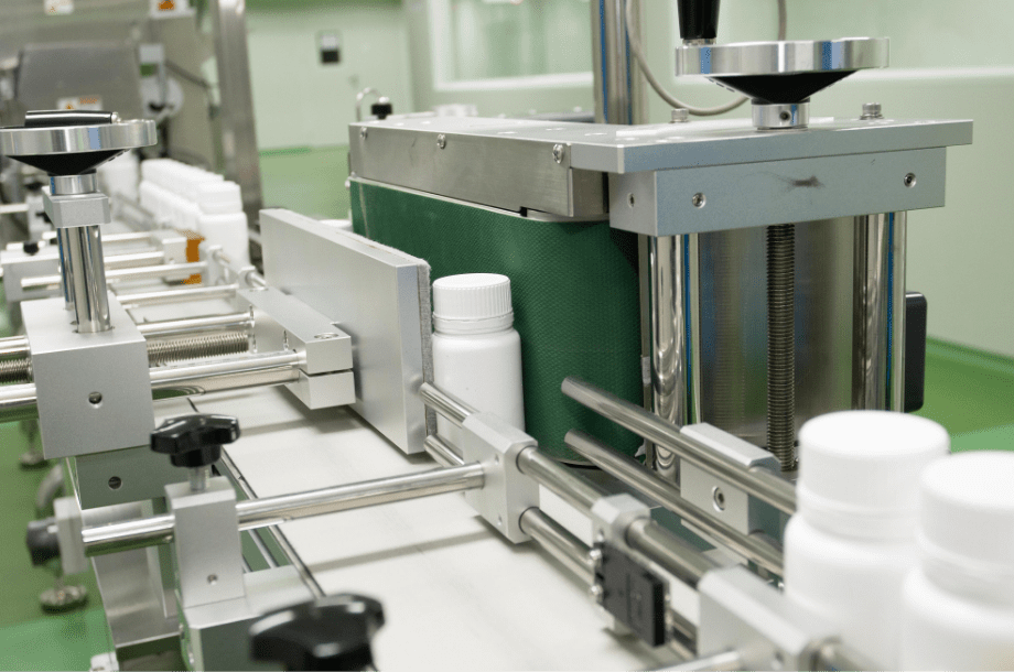 Automatic capping head sealing bottles on the A Block production line