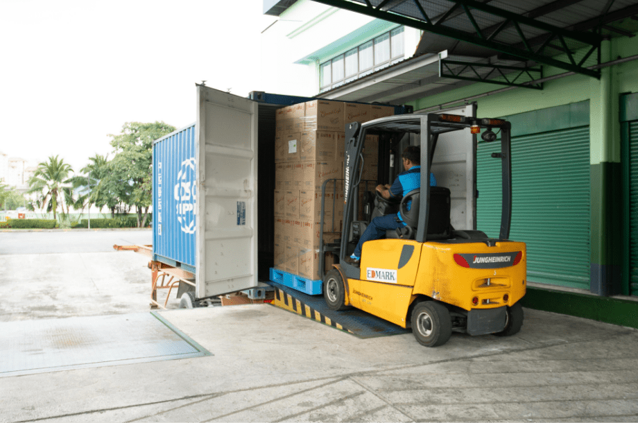 Forklift loading a shipping container at the Edmark Industries loading bay