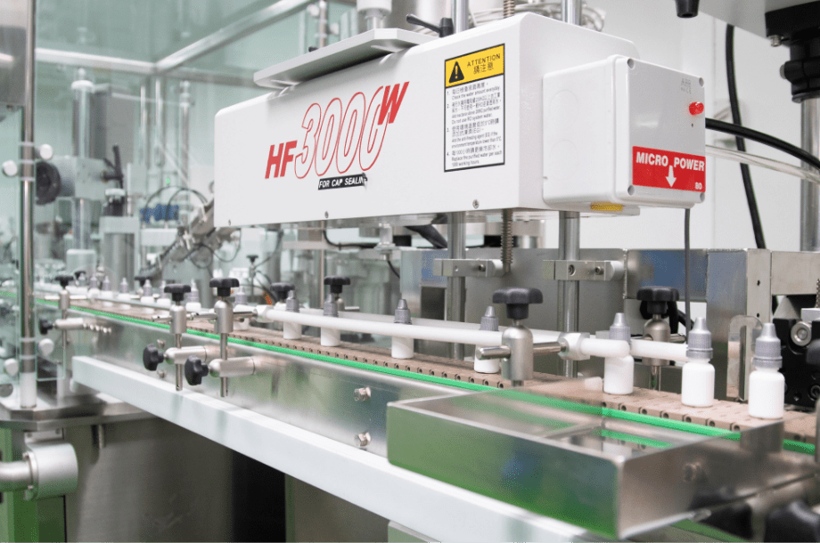 Labelling machine applying labels to bottles in D Block