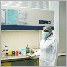 Laboratory technician working at the fume hood in the laboratory block