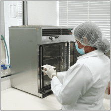 Technician loading samples into a stability testing chamber