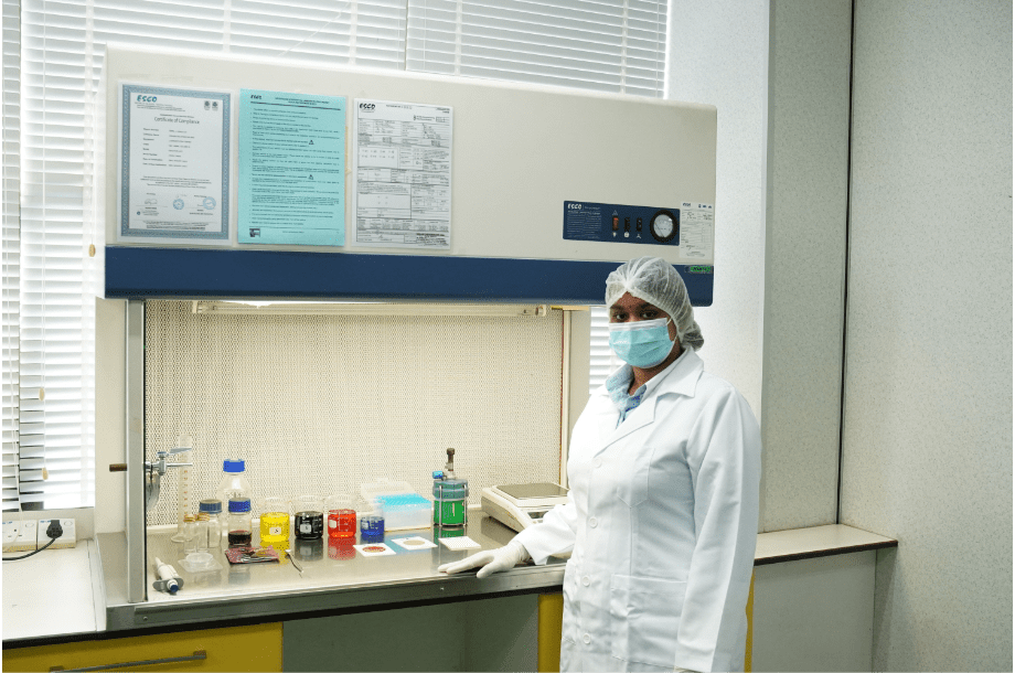 Laboratory technician working at the fume hood in the laboratory block