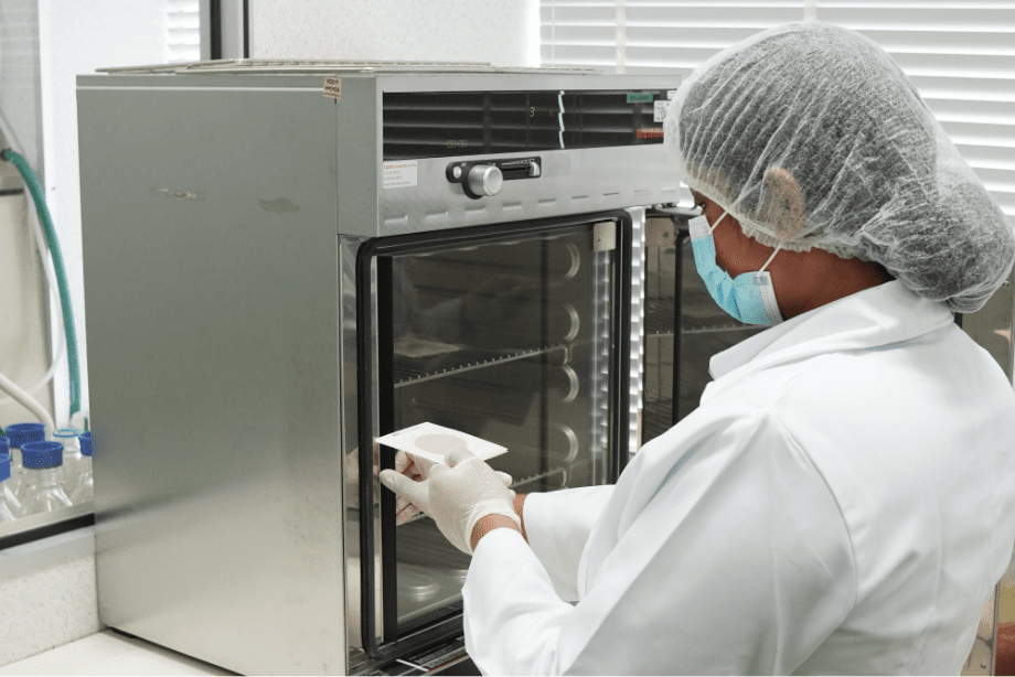 Technician loading samples into a stability testing chamber