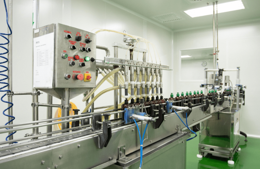 Multi-head filling machine filling amber bottles with traditional herbal liquid