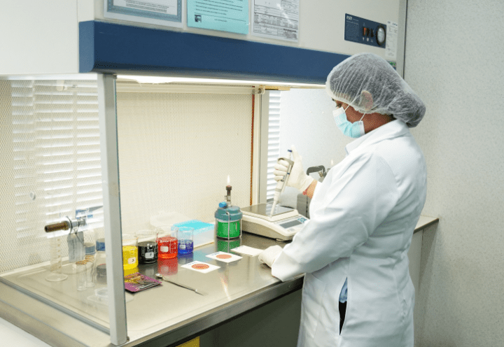 Laboratory technician preparing samples at the fume hood
