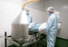 Operators charging powder into the blending hopper