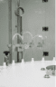 Filling nozzles dosing liquid into white bottles