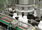 Rotary machine feeding supplement jars on the filling line
