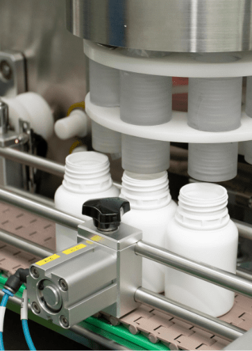 Rotary machine feeding supplement jars on the filling line