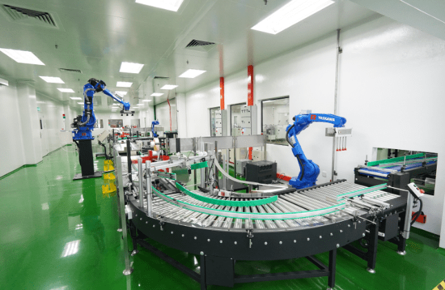 Robotic arms on the curved conveyor of the automated packing line