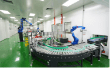 Robotic arms on the curved conveyor of the automated packing line