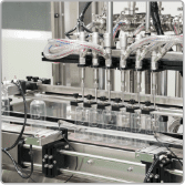 Clear spray bottles under the filling nozzles on the home care line