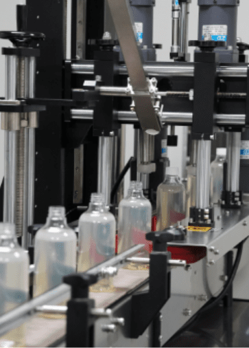 Home care bottles moving through the capping station