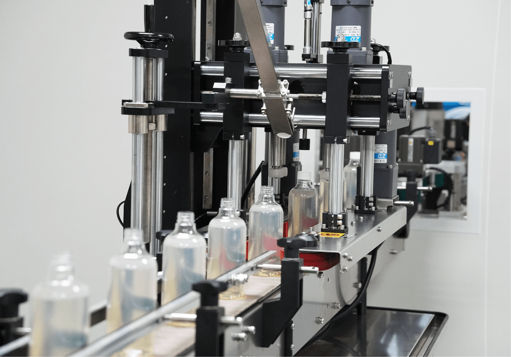 Home care bottles moving through the capping station