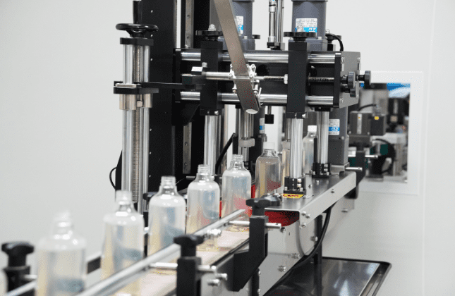 Home care bottles moving through the capping station