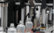 Home care bottles moving through the capping station