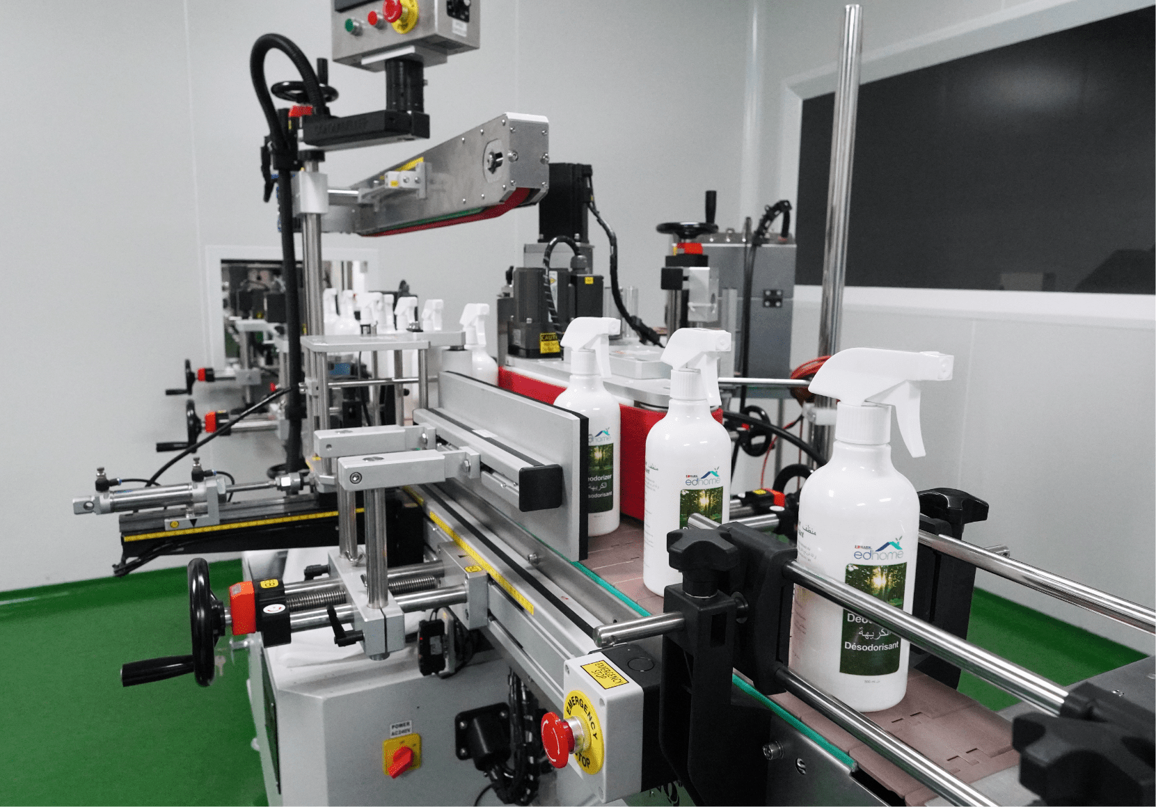 White trigger spray bottles passing through the labelling machine