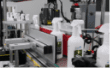 White trigger spray bottles passing through the labelling machine