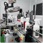 White trigger spray bottles passing through the labelling machine