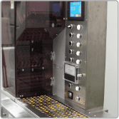 Softgel capsules in carrier trays inside the processing machine