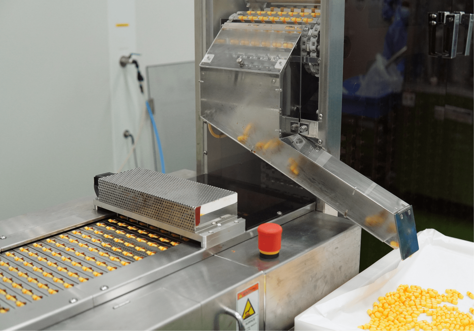 Softgel capsules on the discharge chute of the encapsulation machine