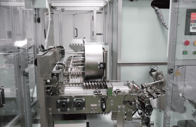 Transfer chain feeding the cartoning machine