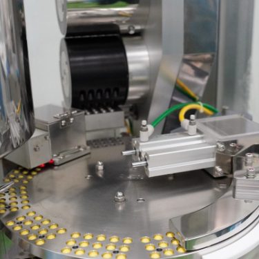 Automated capsule and liquid filling machine at Edmark Industries facility