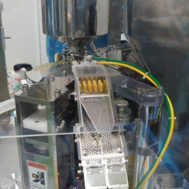 Automated capsule and liquid filling machine at Edmark Industries facility