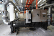 Water-cooled chiller unit and control panel in the Edmark Industries plant room