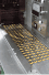 Capsules on the stainless steel conveyor of the high-speed packing line