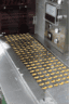 Capsules on the stainless steel conveyor of the high-speed packing line